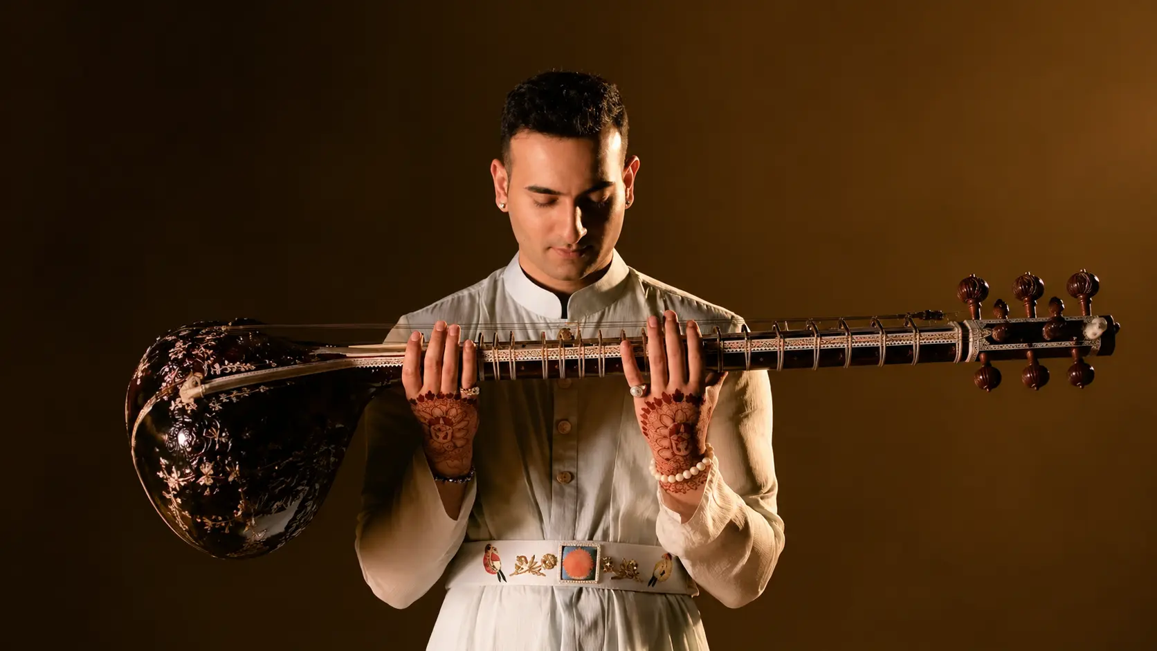 Rishab Sharma holding a sitar